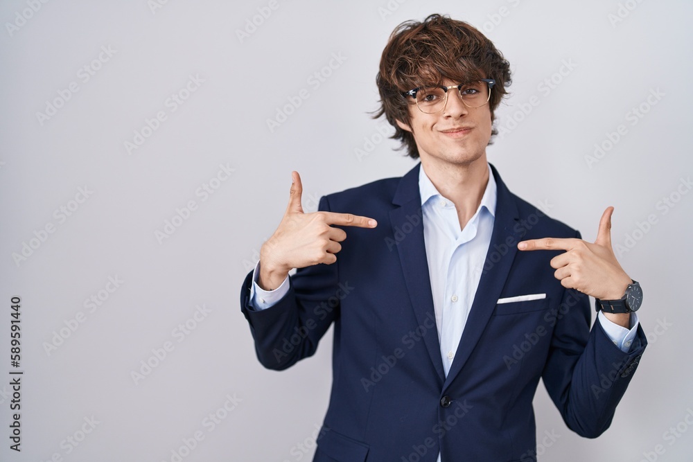 Hispanic business young man wearing glasses looking confident with smile on face, pointing oneself with fingers proud and happy. Hispanic business young man wearing glasses looking confident with smile on face, pointing oneself with fingers proud and happy.
