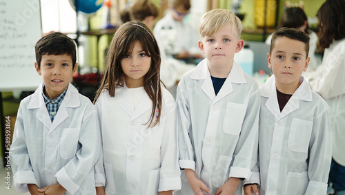 Group of kids scientists students standing with relaxed expression at laboratory classroom
