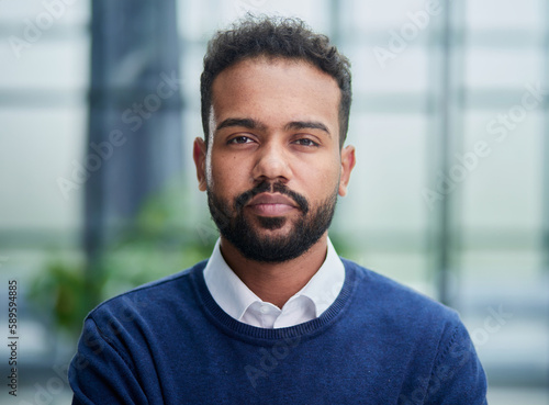 Smiling millennial confident black guy posing for photo, looking at camera