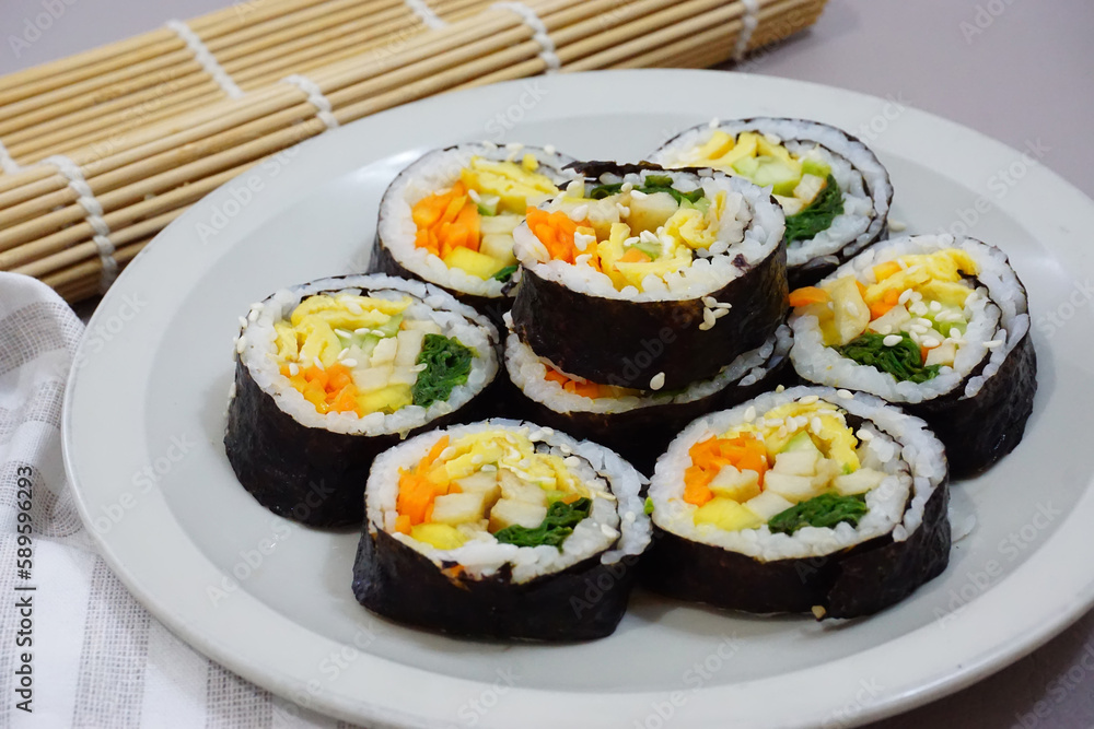 Gimbab, korean sushi roll served on a plate. seaweed rice roll made of gim. Korean street food. Gimbab, korean sushi roll served on a plate. seaweed rice roll made of gim. Korean street food.