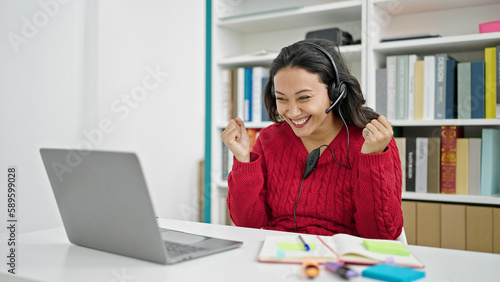 Young beautiful hispanic woman student smiling confident having video call at library university