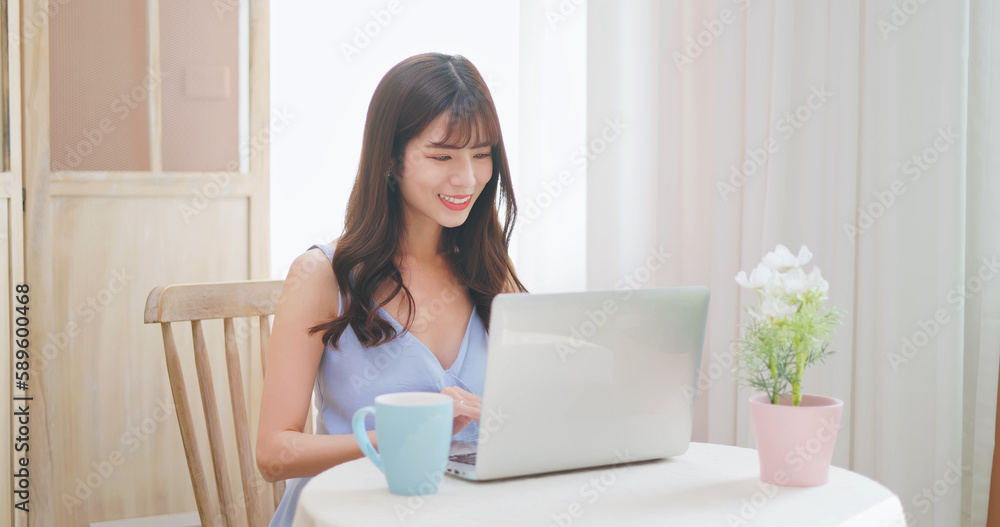 asian woman using notebook easily