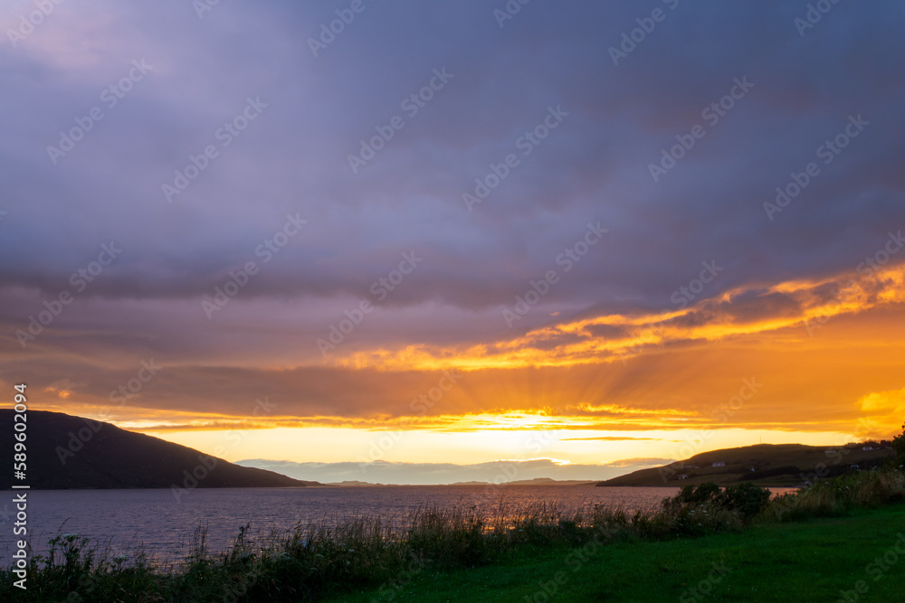 Dramatic sunset over Loch Broom in Ullapool, Highlands, Scotland UK