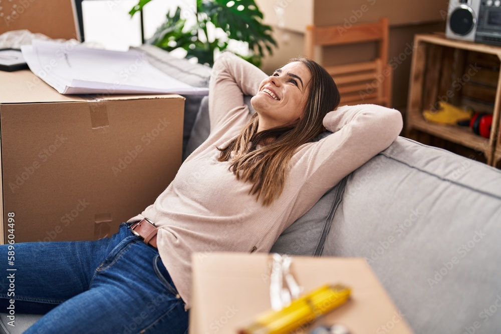Young beautiful hispanic woman smiling confident relaxed on sofa at new home Young beautiful hispanic woman smiling confident relaxed on sofa at new home