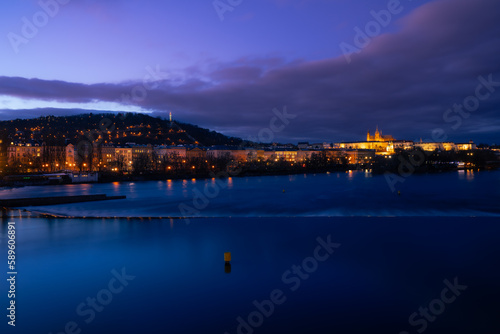 Dreamy night view to the Prague Castle from Vltava river with magical sky and lights from streets on the evening  in the Old Town of amazing historic city Prague, Czech Republic, Europe.