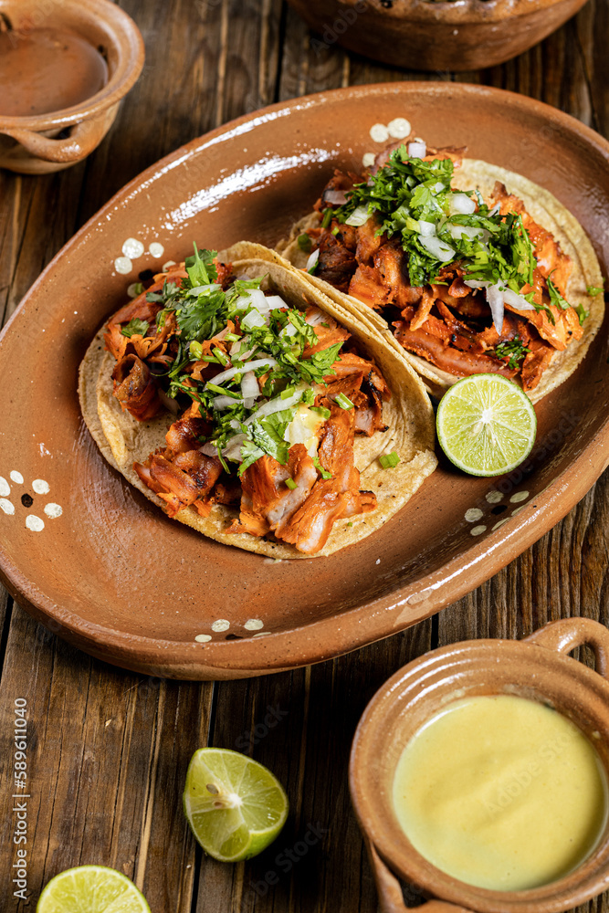 delicious al pastor beef tacos with cilantro and onion on a clay plate