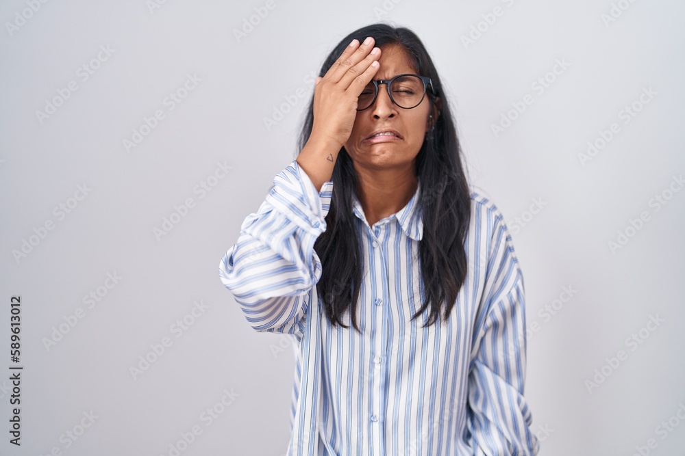 Young hispanic woman wearing glasses yawning tired covering half face, eye and mouth with hand. face hurts in pain. Young hispanic woman wearing glasses yawning tired covering half face, eye and mouth with hand. face hurts in pain.