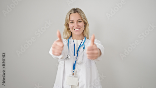 Young blonde woman doctor doing thumbs up over isolated white background