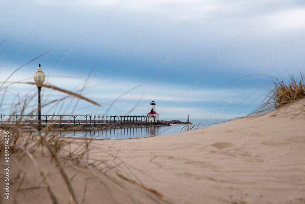 Michigan City Lighthouse and beach with storm clouds approaching.  Michigan city, Indiana, USA.