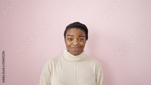 African american woman smiling confident standing over isolated pink background