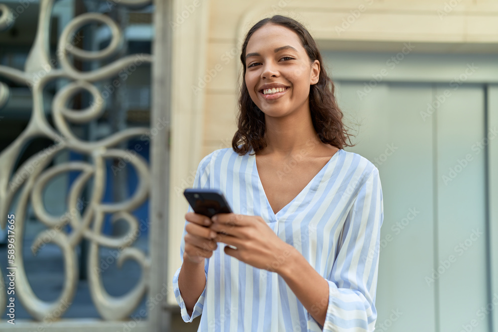 Young african american woman smiling confident using smartphone at coffee shop terrace Young african american woman smiling confident using smartphone at coffee shop terrace