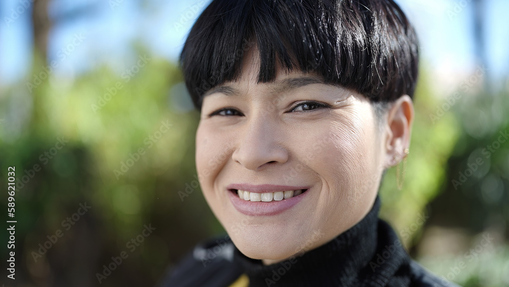 Young chinese woman smiling confident standing at park Young chinese woman smiling confident standing at park
