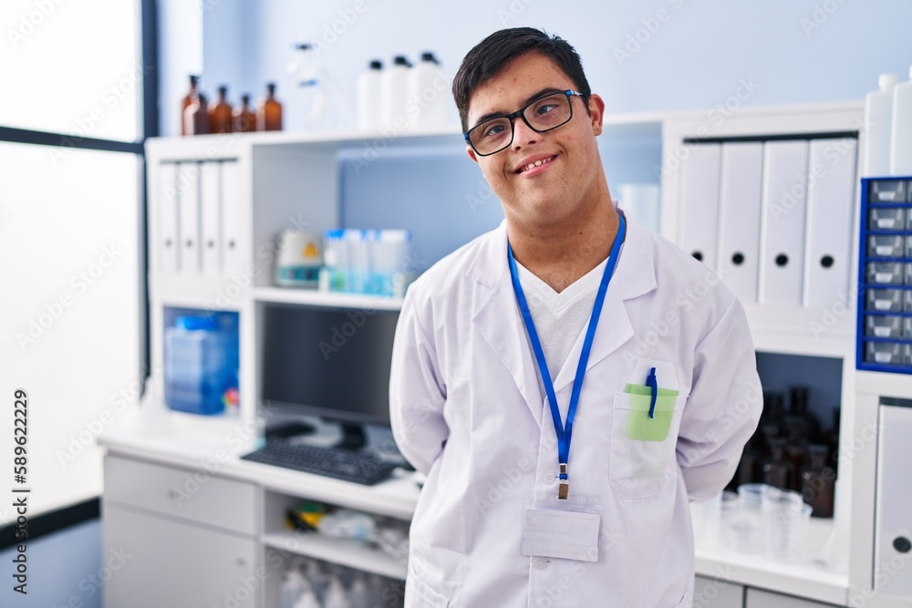 Down syndrome man wearing scientist uniform standing at laboratory Down syndrome man wearing scientist uniform standing at laboratory