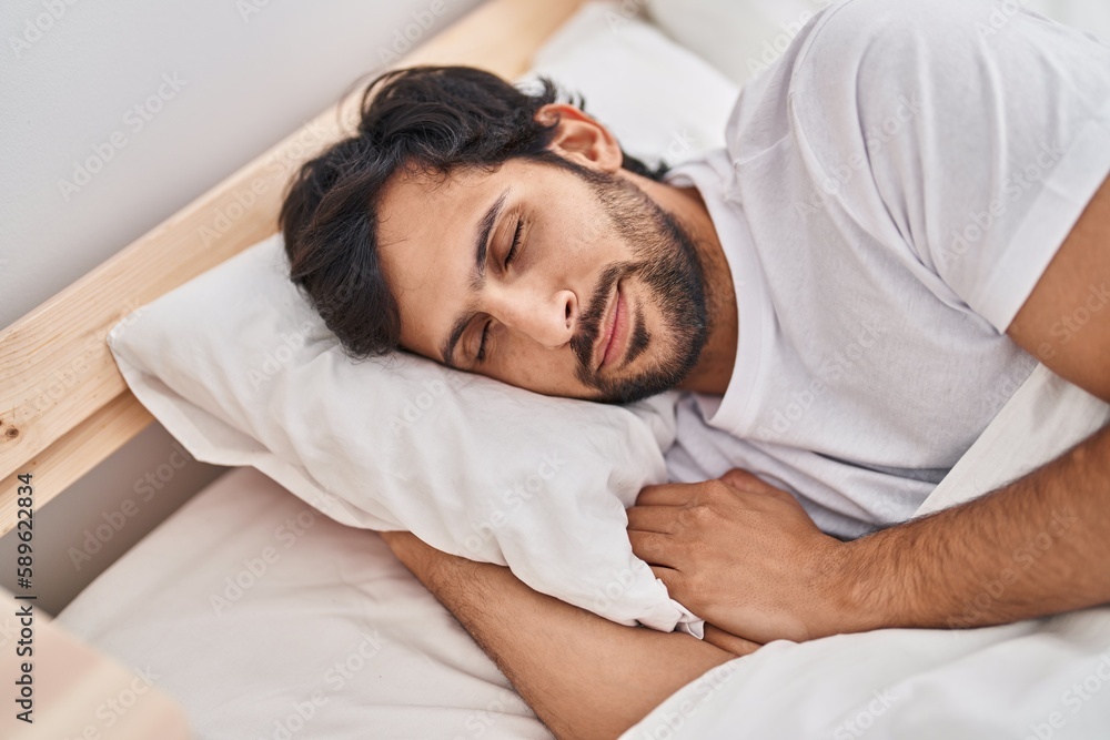 Young hispanic man lying on bed sleeping at bedroom Young hispanic man lying on bed sleeping at bedroom