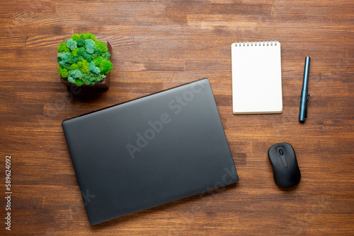 Flat lay photo of Office table with laptop computer, notebook, digital tablet, Pencil on wooden background. Desktop office mockup concept.