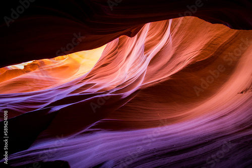 Antelope Canyon in the Navajo Reservation Page Northern Arizona. Famous slot canyon. Light showing off the glamorous detail of the ancient spiral rock arches. Myriad of shadows and soft bright colors