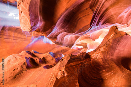 Upper Antelope Canyon in the Navajo Reservation Page Arizona. Light showing off the glamorous detail of the ancient spiral rock arches. Multicolored spectrum of color orange and red.