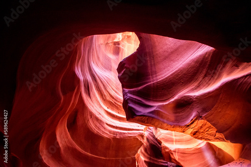 Antelope Canyon in the Navajo Reservation Page Northern Arizona. Famous slot canyon. Light showing off the glamorous detail of the ancient spiral rock arches. Multicolored texture, rock formation. 