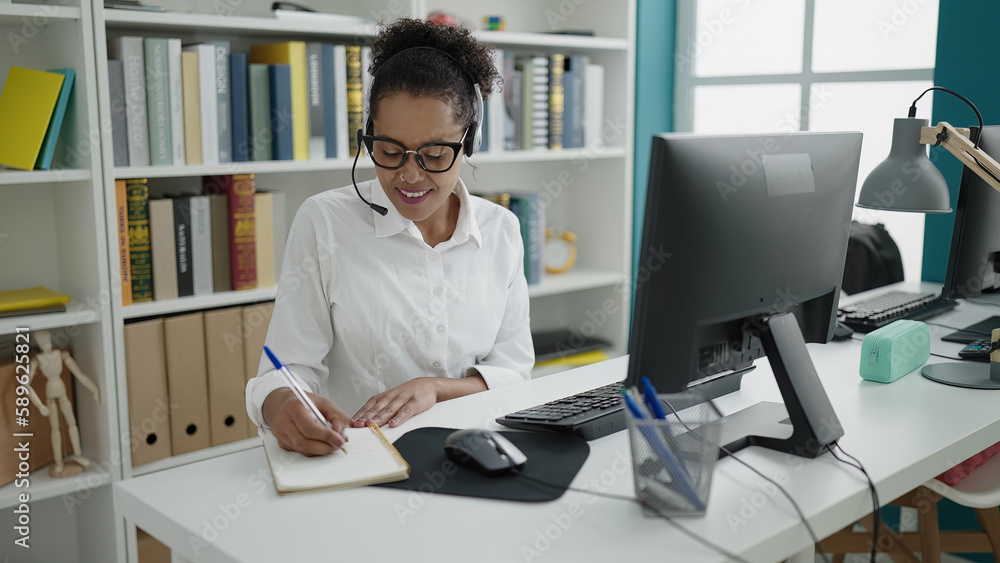 African american woman teacher having video call writing on notebook at library university African american woman teacher having video call writing on notebook at library university