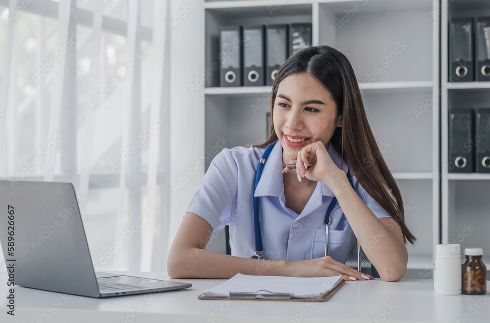 Portrait of smiling young Caucasian female doctor or nurse in white medical uniform in clinic Portrait of smiling young Caucasian female doctor or nurse in white medical uniform in clinic