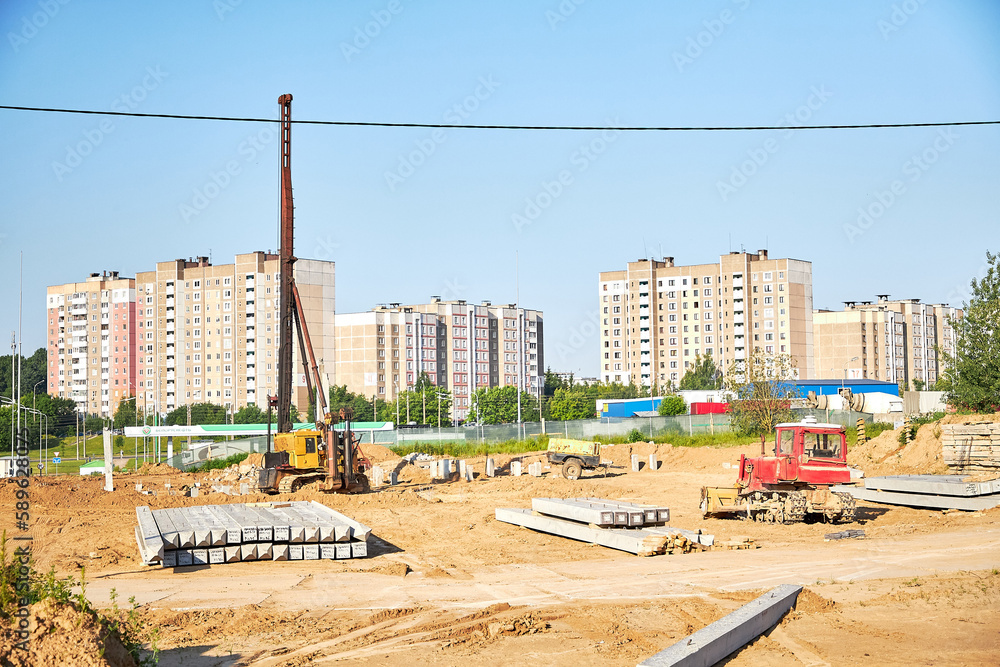 Construction site.Equipment for installing piles in the ground, a heavy machine for driving pillars work when laying the foundation of the building.