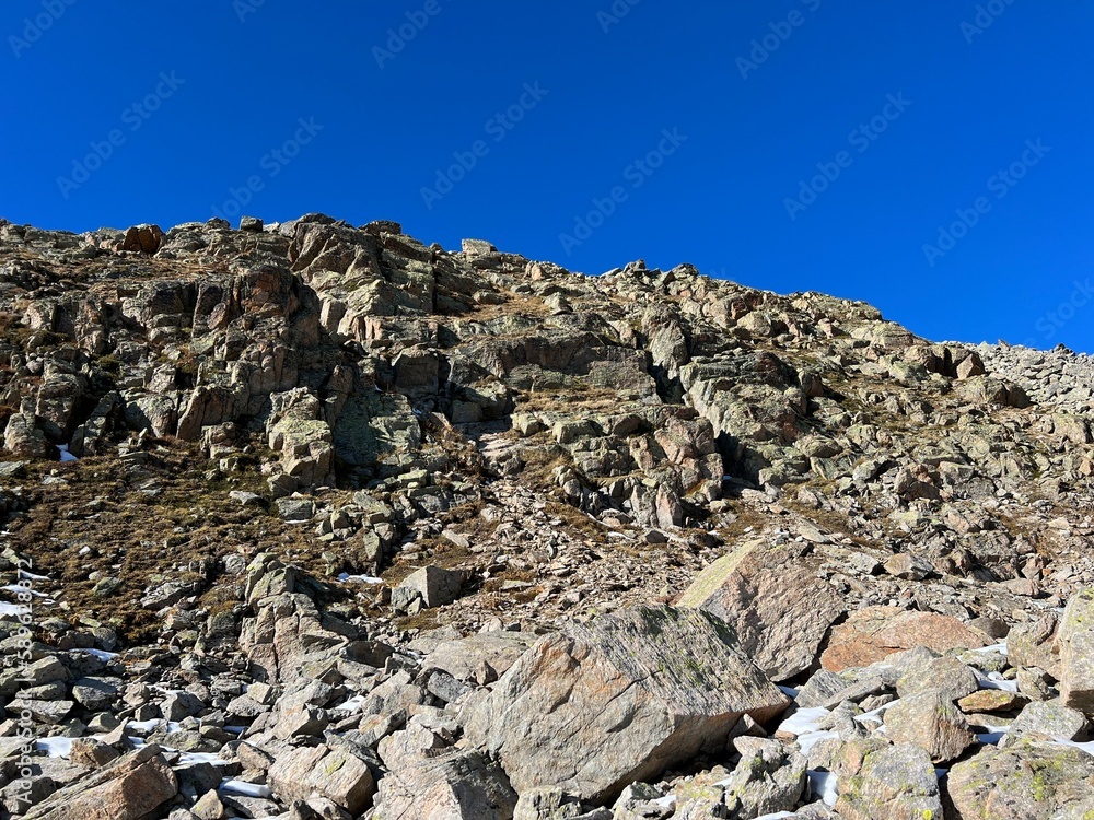 Rocks and stones in the autumn Alpine environment of the Albula Alps and above the Swiss mountain road pass Fluela (Flüelapass), Zernez - Canton of Grisons, Switzerland (Schweiz) Rocks and stones in the autumn Alpine environment of the Albula Alps and above the Swiss mountain road pass Fluela (Flüelapass), Zernez - Canton of Grisons, Switzerland (Schweiz)