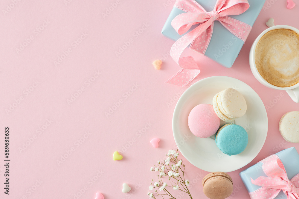 Top view photo of blue gift boxes plate with macaroons cup of coffee small hearts baubles and gypsophila flowers on isolated pastel pink background with empty space. Mother's Day concept Top view photo of blue gift boxes plate with macaroons cup of coffee small hearts baubles and gypsophila flowers on isolated pastel pink background with empty space. Mother's Day concept