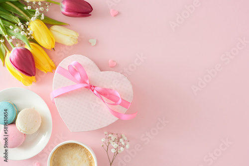 Women's Day celebration concept. Top view photo of heart shaped giftbox cup of coffee macaroons small hearts bunch of colorful tulips and gypsophila flowers on pastel pink background with empty space