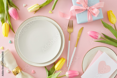 Women's Day concept. Top view photo of empty circle plate cutlery knife fork napkin with ring tulips flowers postcard gift box and small hearts baubles on pastel pink background
