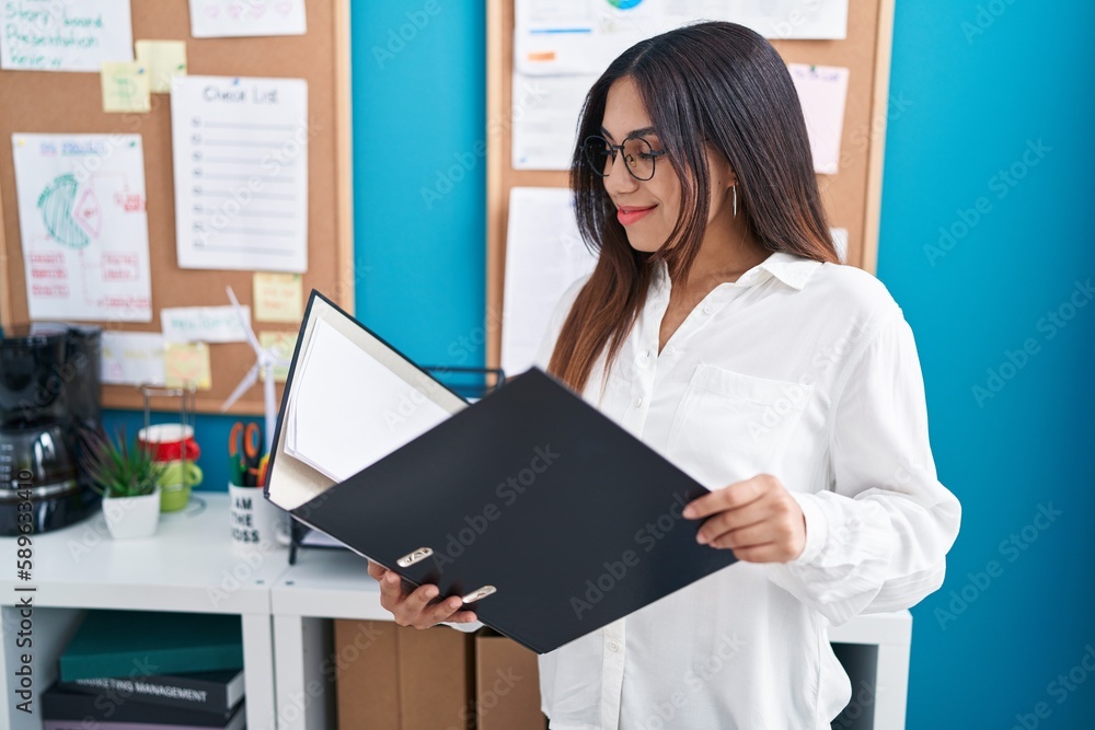 Young beautiful arab woman business worker reading document at office Young beautiful arab woman business worker reading document at office
