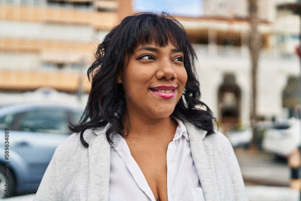 Young beautiful latin woman smiling confident looking to the side at street Young beautiful latin woman smiling confident looking to the side at street