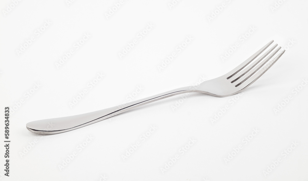 Metal fork lying on a white background. Front view. Metal fork lying on a white background. Front view.