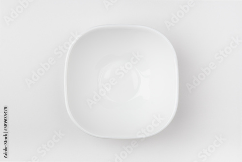 An empty white bowl on a white background. Blank plate. Top view.