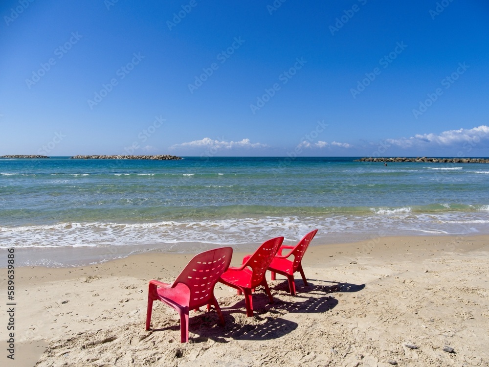 Chairs and lounges at the spectacular sandy beach of Netanya, Israel. Mediterranean coast on a sunny day Chairs and lounges at the spectacular sandy beach of Netanya, Israel. Mediterranean coast on a sunny day