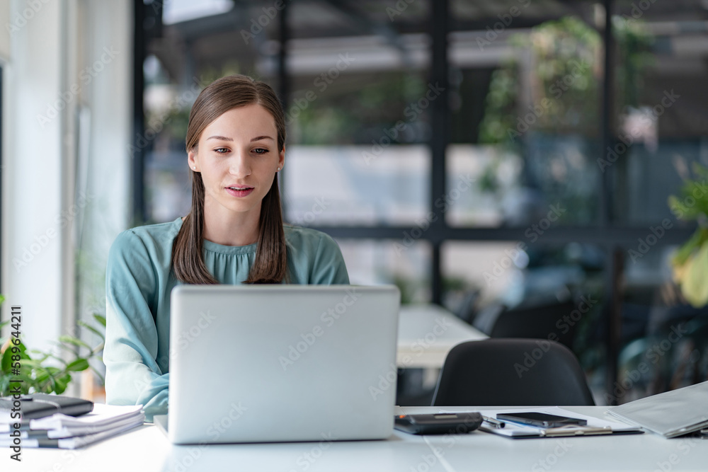 Millennial confident Female working in creative office.. Millennial confident Female working in creative office..