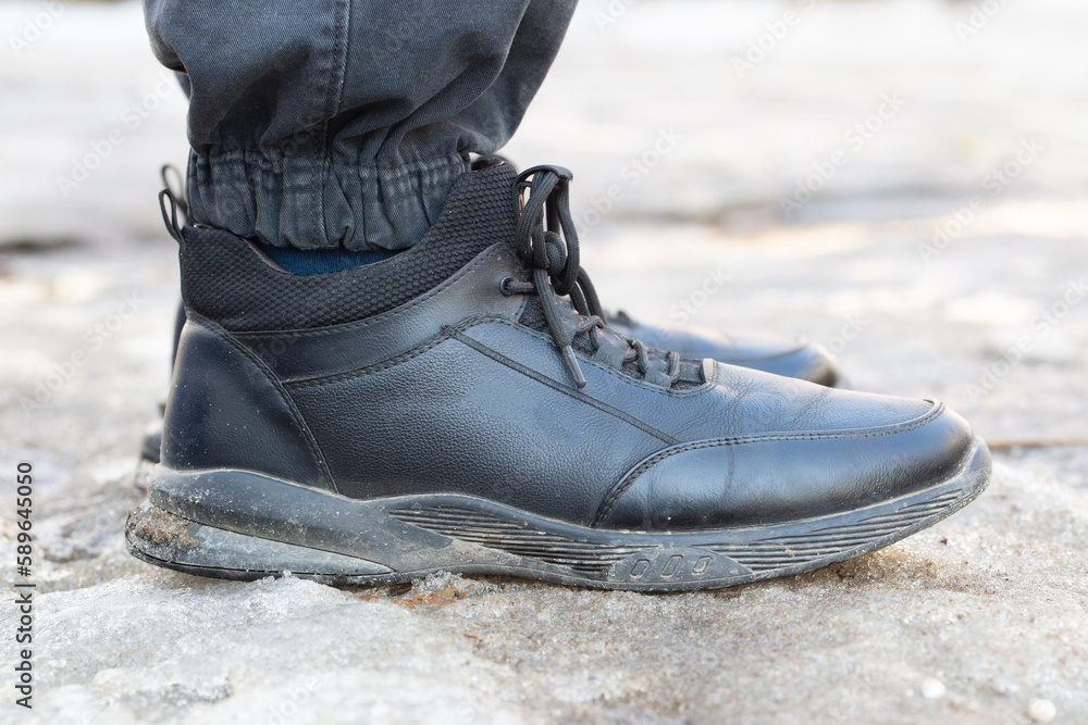 Dirty shoes on the feet of a man.Casual spring shoes. Dirty shoes on the feet of a man.Casual spring shoes.