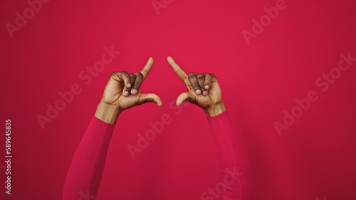 African american woman doing frame gesture with hands at street