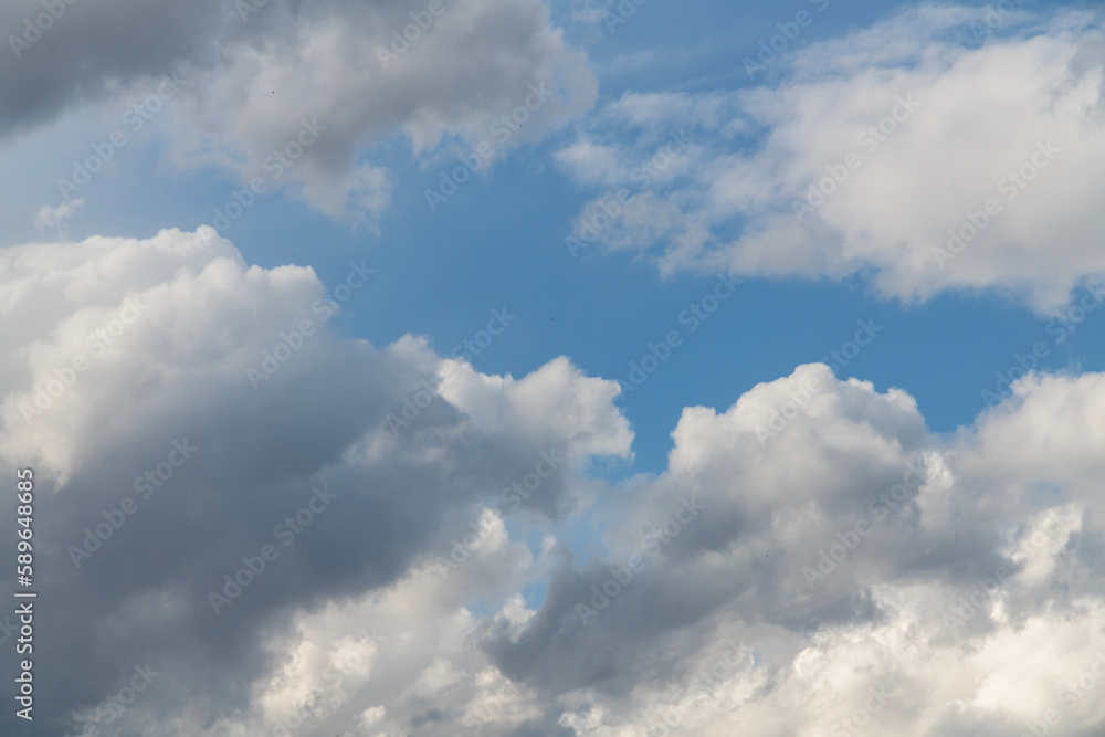 Beautiful huge fluffy clouds on the blue sky. Sky clouds background. Beautiful huge fluffy clouds on the blue sky. Sky clouds background.