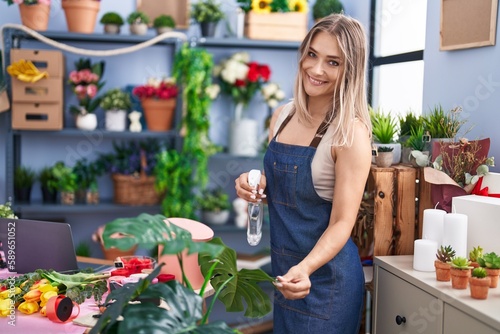 Young caucasian woman florist smiling confident working at florist