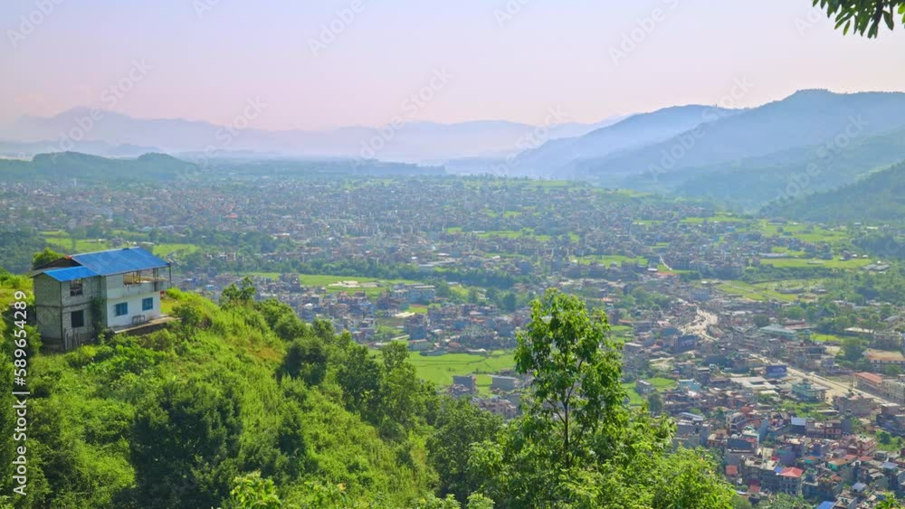 Aerial view overlooking the city of Pokhara, Nepal. Dense smog and fog cover the city and surrounding mountains on a sunny day Aerial view overlooking the city of Pokhara, Nepal. Dense smog and fog cover the city and surrounding mountains on a sunny day
