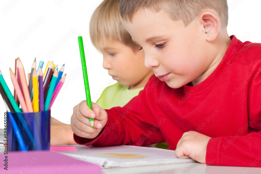 Two little boys studying math at class with green chalk board on background