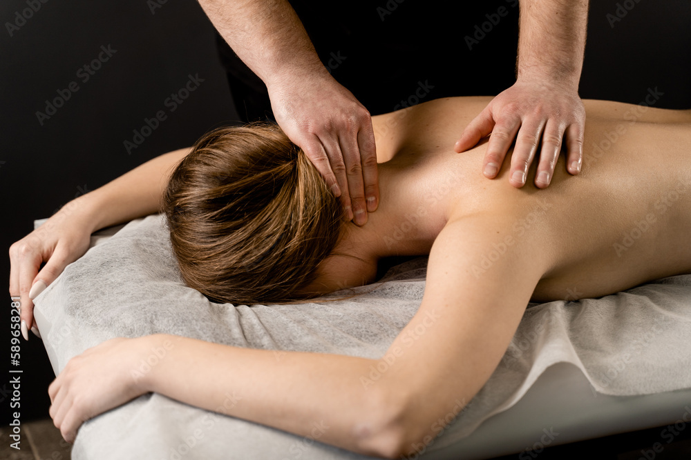 Classic massage close-up. Therapeutic massage with manipulating body to promote relaxation and reduce stress. Massage therapist use techniques such as friction, stretching, and tapping.