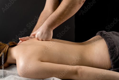 Classic massage close-up. Therapeutic massage with manipulating body to promote relaxation and reduce stress. Massage therapist use techniques such as friction  stretching  and tapping.