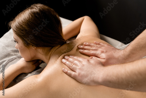 Classic massage close-up. Therapeutic massage with manipulating body to promote relaxation and reduce stress. Massage therapist use techniques such as friction, stretching, and tapping.