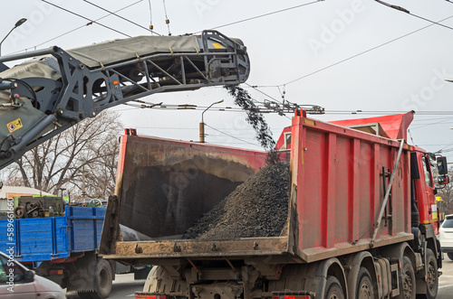 Loading heavy dump truck with crushed asphalt
