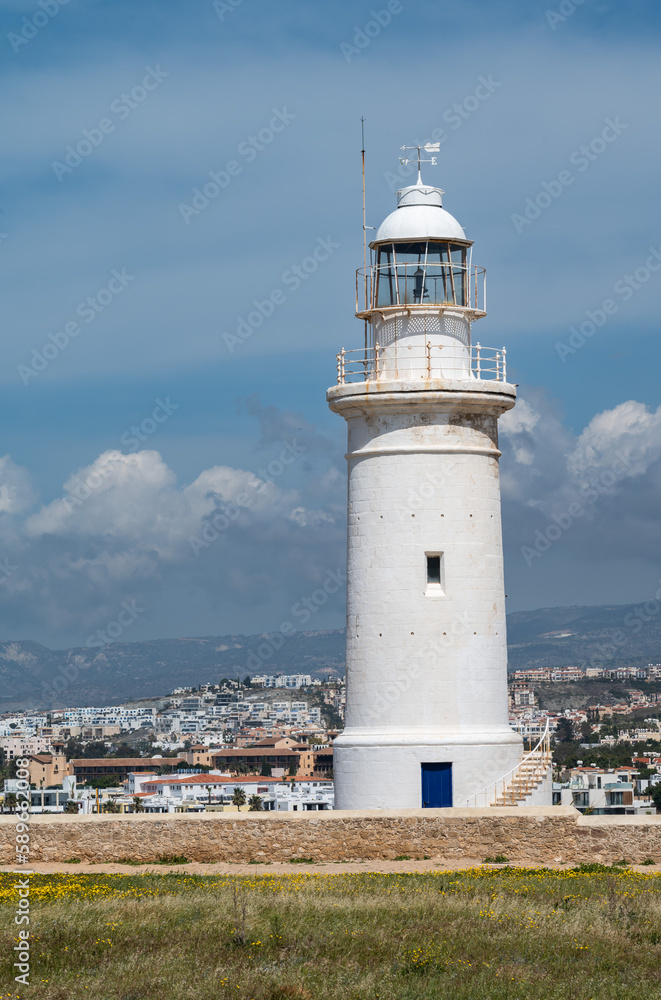 Paphos, Paphos District, Cyprus -  View over the historical lighthouse at the coast against blue sky