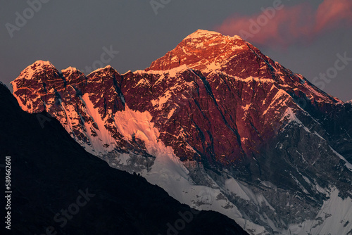 Pink sunset at Mount Everest and Nuptse with marshmallow cloud over Everest 
