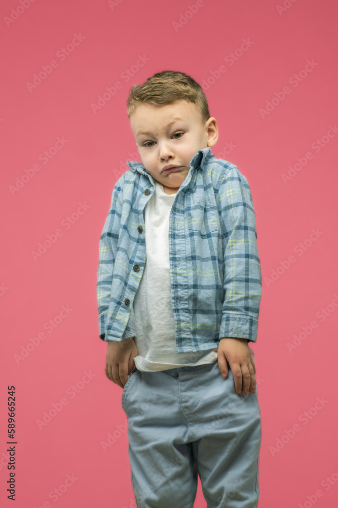 Puzzled and clueless child boy, shrugging his shoulders, saying: I don't know. Negative human emotions, facial expressions, life perception and attitude. Puzzled and clueless child boy, shrugging his shoulders, saying: I don't know. Negative human emotions, facial expressions, life perception and attitude.