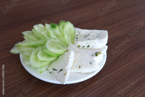 fresh cheese and cucumber on a plate 