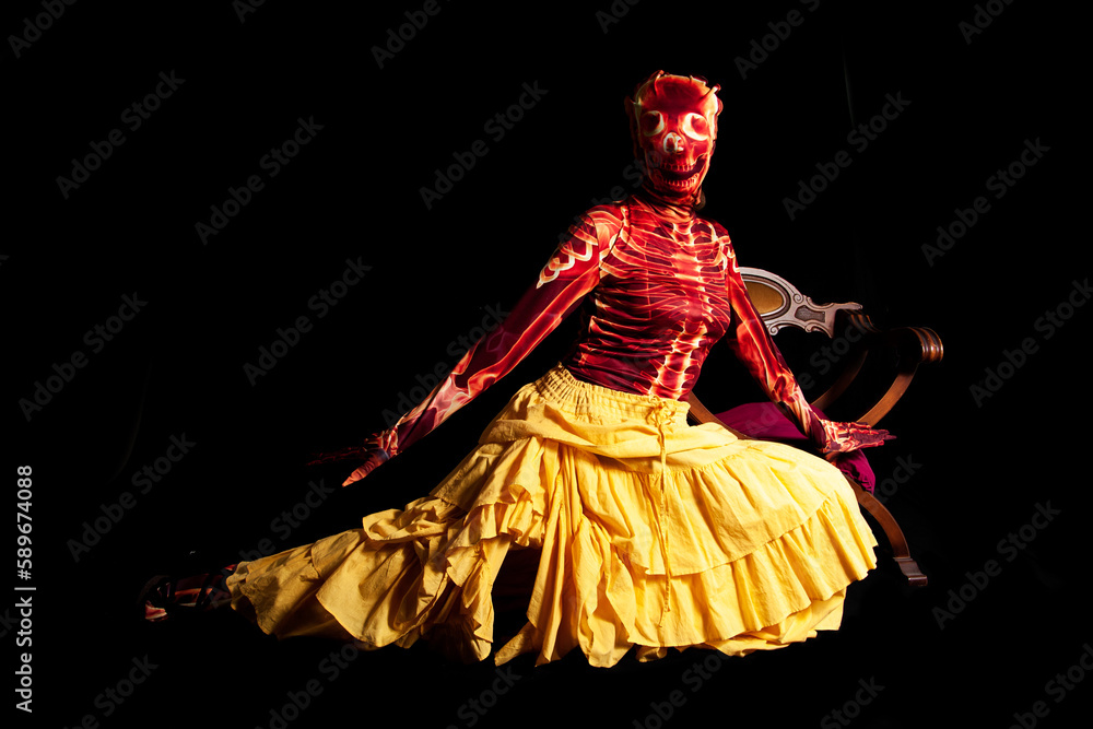 sensual woman dressed in a skeleton costume posing wearing a yellow skirt on a black background sensual woman dressed in a skeleton costume posing wearing a yellow skirt on a black background